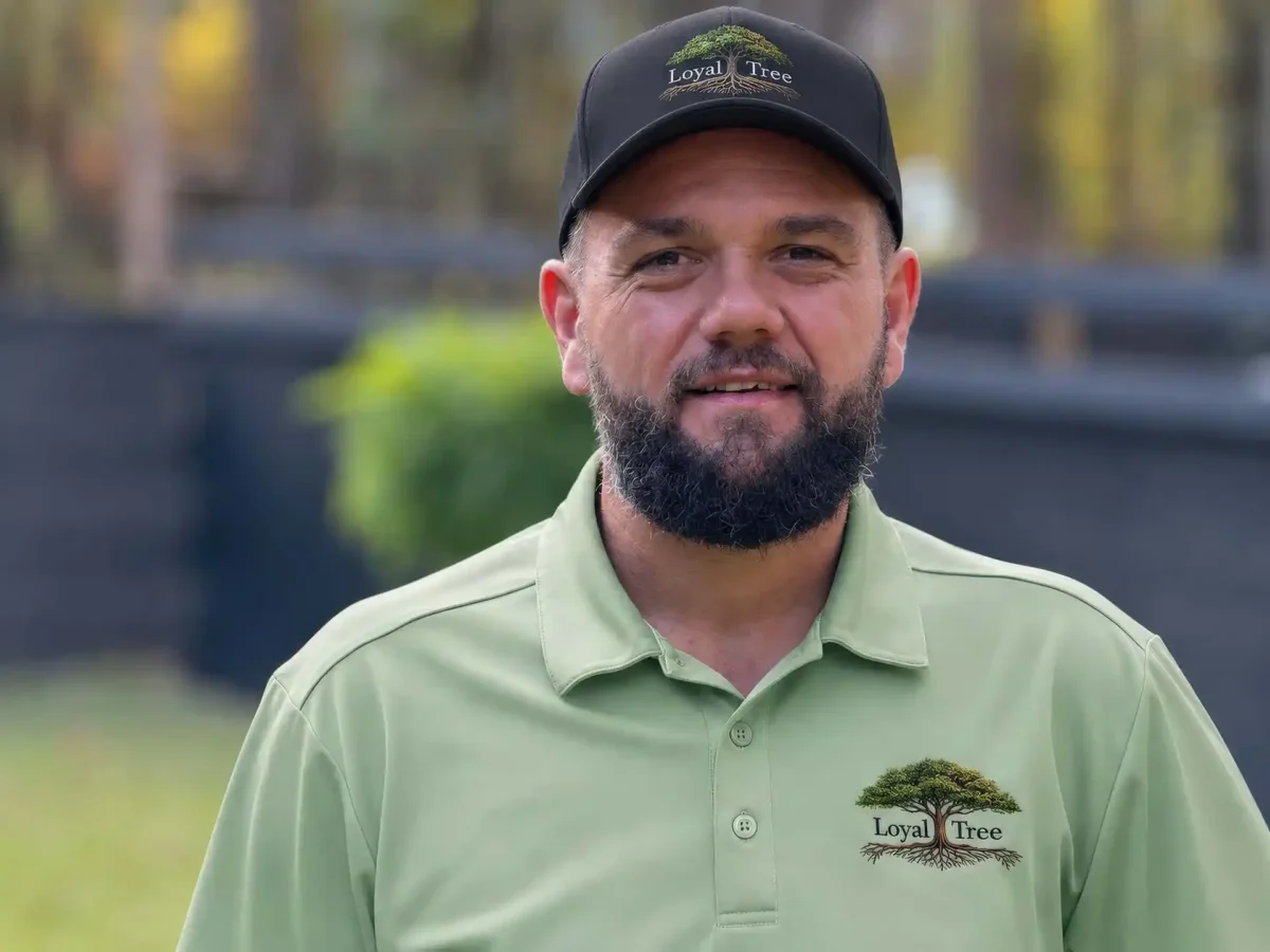 Portrait of LoyalTree owner Michael Williams, lead arborist, in a company polo